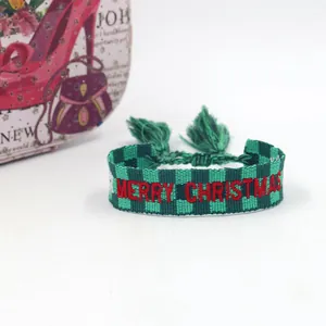 Detail of green plaid embroidered Christmas bracelet with tassels and adjustable closure