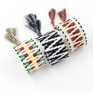 Detailed view of woven ethnic friendship bracelets with colorful fringe tassels in three patterns