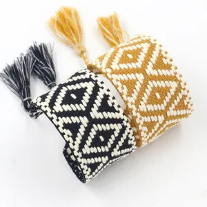 Detailed view of bohemian woven bracelets with geometric patterns and tassel accents