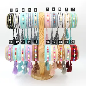 Detailed view of twenty unique Bohemian woven friendship bracelets with tassels and beads