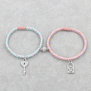 Braided friendship bracelets with magnetic sphere and rhinestone lock and key pendants