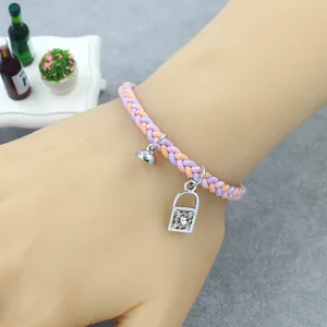 Detailed view of woven lavender and orange friendship bracelets with magnet and rhinestone lock