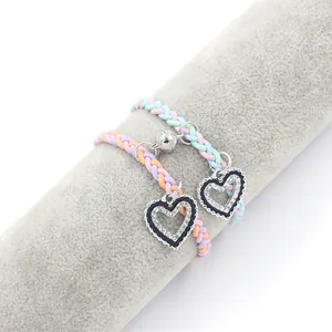Close-up of magnetic woven friendship bracelets with rhinestone-encrusted heart charms