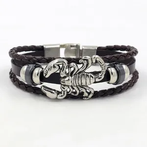 Detail of multi-layer leather bracelet featuring a silver metal scorpion and press buckle