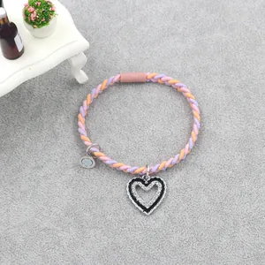 Handwoven heart pendant bracelet with purple and orange cords and magnetic clasp