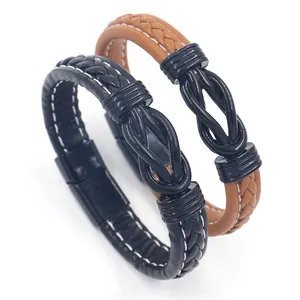 Detail of black and brown braided leather bracelets with a magnetic metal infinity clasp