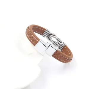 Men's brown leather braided bracelet with silver magnetic buckle and metal knot detail