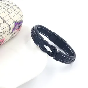 Macro detail of black braided leather bracelet with infinity knot and white stitching