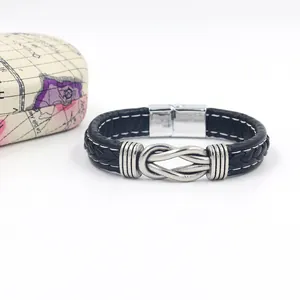 Detail of men's black woven leather bracelet with silver knot and magnetic clasp