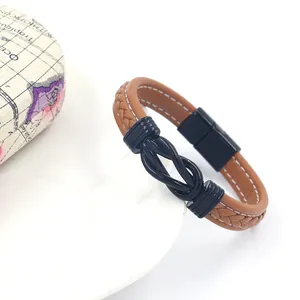 Close-up of brown leather men's bracelet with black nautical knot and magnetic clasp
