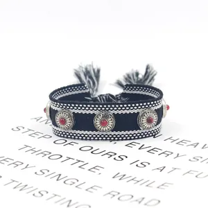 Bohemian woven friendship bracelet with silver metal studs and black white tassels