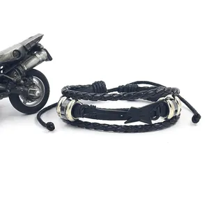 Handmade woven leather bracelet with silver guitar pendant and motorcycle background