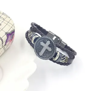 Detailed macro view of retro multi-layer woven leather bracelet with cross emblem