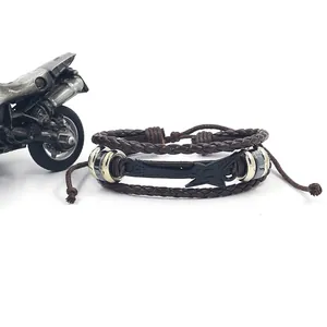 Handwoven multilayer leather bracelet with black guitar charm on white background