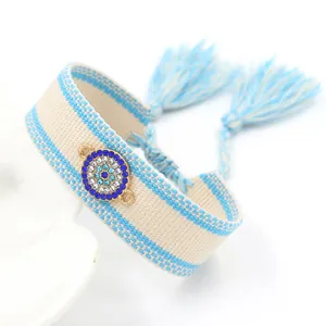 Bohemian evil eye woven bracelet with blue rhinestones and tassel charms for women