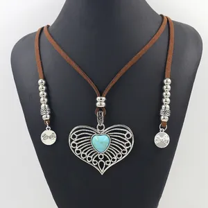 Antique silver heart necklace with turquoise stone on a brown suede leather cord