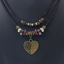 Close-up of bronze heart pendant engraved with Mother Love Always Forever on black cord