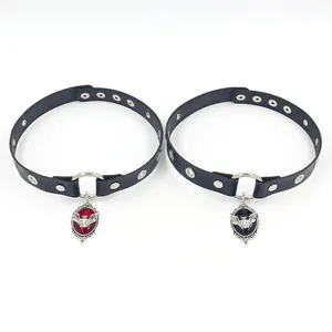 Detail of gothic leather chokers with vintage silver bat pendants in red and black