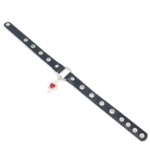 Detail of punk leather choker with silver rivets and red enamel heart pendant charm