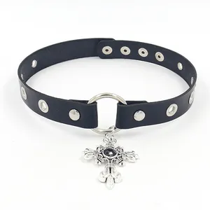 Detail of gothic leather choker with silver cross pendant and black gemstone inlay