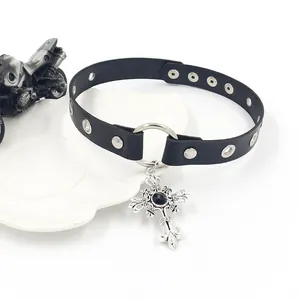 Punk leather choker with thorn cross pendant and silver studs on white display