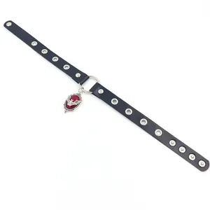 Macro detail of leather choker featuring silver studs and vintage red bat pendant