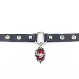 Detailed view of Gothic black leather choker with a red bat cameo pendant and metal studs