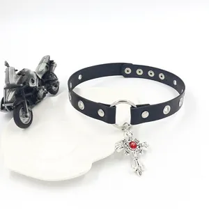 Close-up of black leather punk choker with silver cross and red gemstone detail