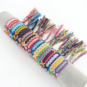 Detailed view of colorful handmade woven friendship bracelets with tassel ties and geometric patterns