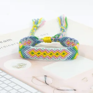 Macro detail of handmade bohemian woven friendship bracelet with colorful diamond patterns