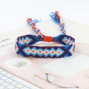 Detail of handmade bohemian woven bracelet with colorful geometric diamond patterns