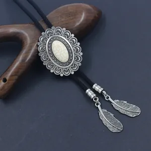 Vintage Bolo Tie with white turquoise gemstone and silver feather pendants on black cord