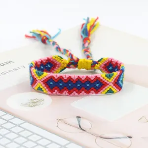 Detailed close-up of handmade woven friendship bracelet with colorful geometric patterns