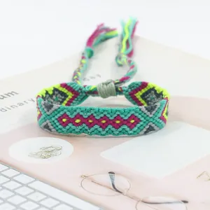 Close-up of handmade woven friendship bracelet with colorful geometric patterns and tassels