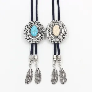 Detail of vintage Bolo Tie with oval turquoise stone inlay and metal feather charms