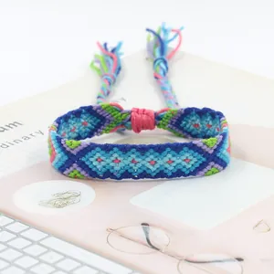Detailed close-up of handmade woven friendship bracelet with colorful geometric patterns