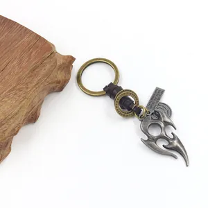 Detail of vintage flame totem pendant with braided leather strap and engraved metal tag