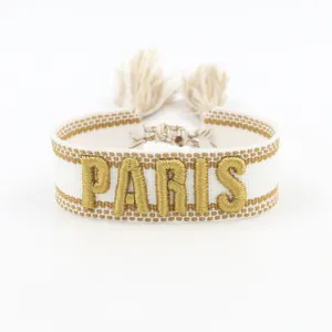 Embroidered white and gold PARIS lettered woven cotton friendship bracelet with tassels