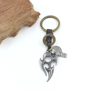 Vintage bronze flame totem pendant with braided leather keychain on a white background