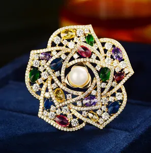 Classic camellia brooch with white pearl and colorful zircons on navy velvet