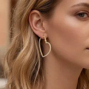Close-up detail of a luxury gold-plated hollow heart hoop earring with pave crystals