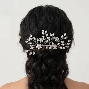Detail of bridal hair comb with pearls and rhinestones on elegant black updo