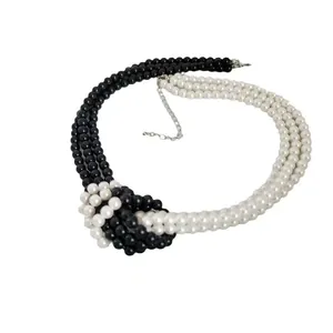 Multi-layer black and white faux pearl necklace with woven knot and silver clasp