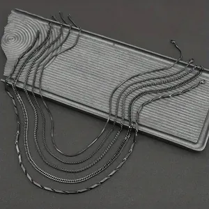 Black titanium steel necklace set featuring snake, curb, and Cuban link chain styles