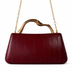 Deep red PU leather handbag featuring unique vertical textures and wavy gold metal handle