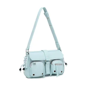 Close-up of light blue shoulder bag featuring multi-pocket design and metal hardware details