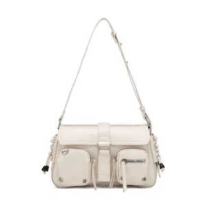 Detail of creamy white Y2K style crossbody bag with multiple pockets and silver zippers
