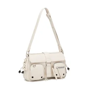 Detailed side view of beige faux leather baguette bag with zip pockets and utility straps