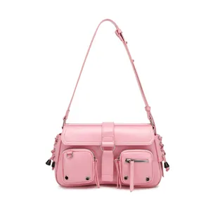 Detail of pink faux leather shoulder bag with functional pockets and silver hardware