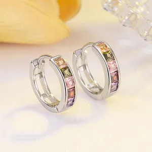 Macro shot of S925 sterling silver hoop earrings with five colorful square gemstones